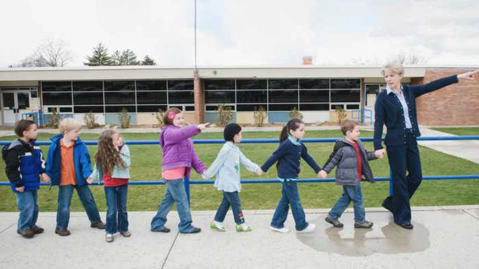 Children in hi-vis jackets on field trip